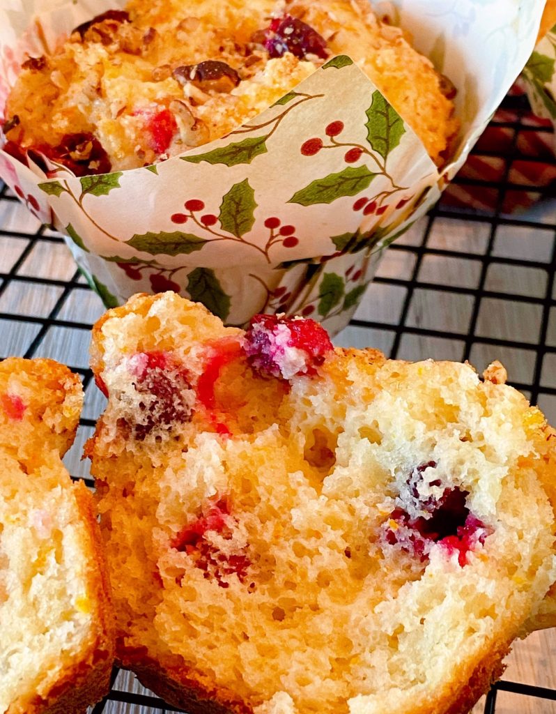 Cranberry Orange Muffin broken open on cooling rack revealing inside.