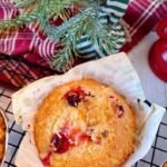 Cranberry Orange Muffin in a Christmas liner on a cooling rack.