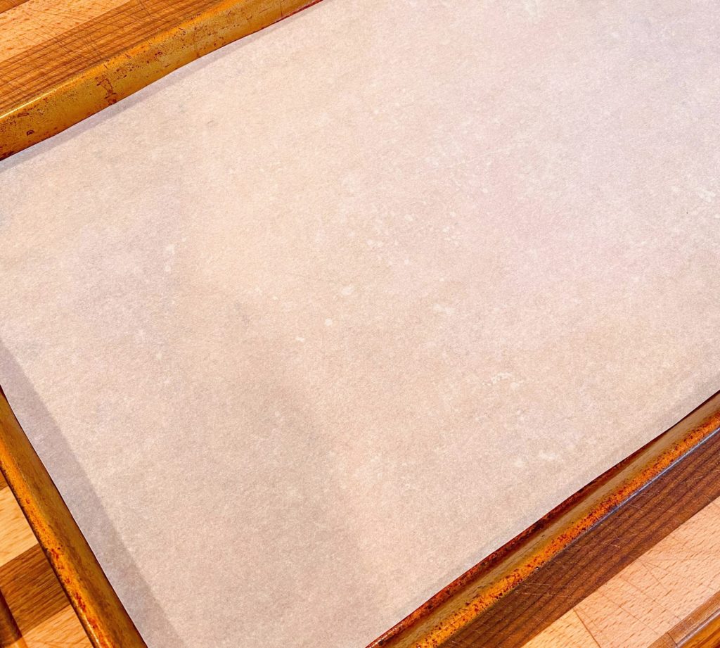 Baking sheet lined with parchment paper for toffee.