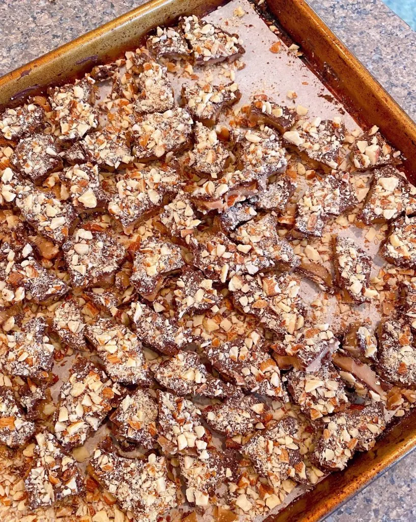 Toffee broken into bite size pieces on the baking sheet. 