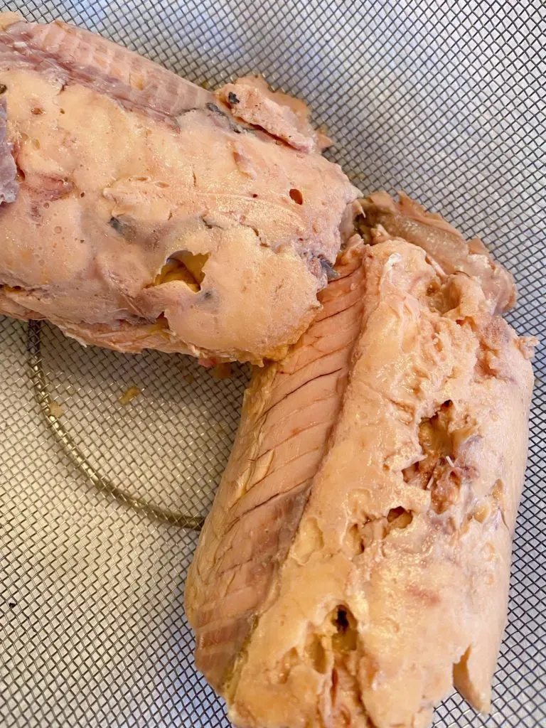 Canned Salmon in a colander draining.