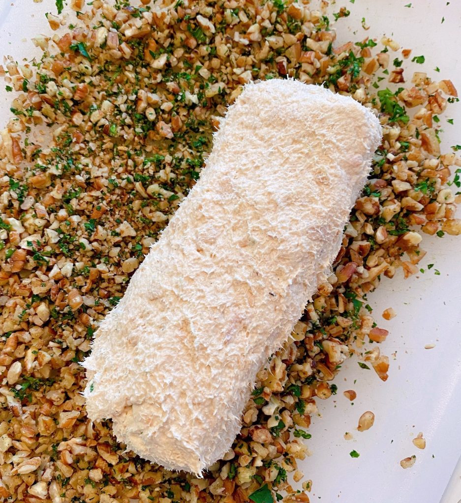 Shaped Salmon log waiting to be rolled in pecans and parsley.