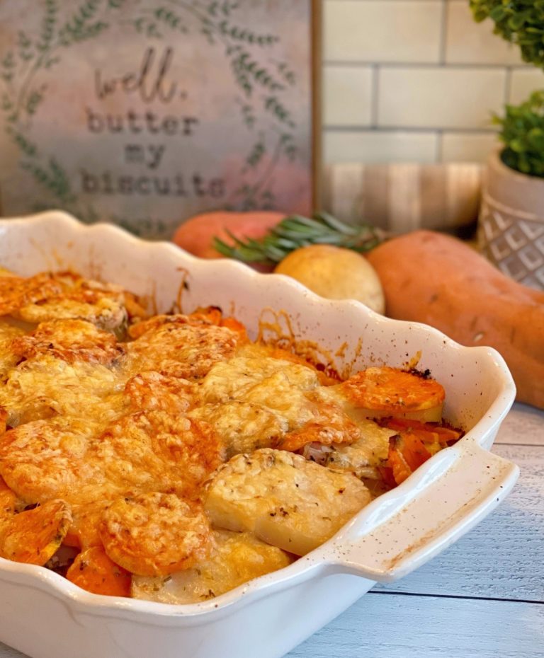 Rosemary Triple-potato gratin in a white baking dish with ingredients behind.