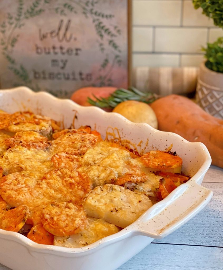 Rosemary Triple-potato gratin in a white baking dish with ingredients behind.