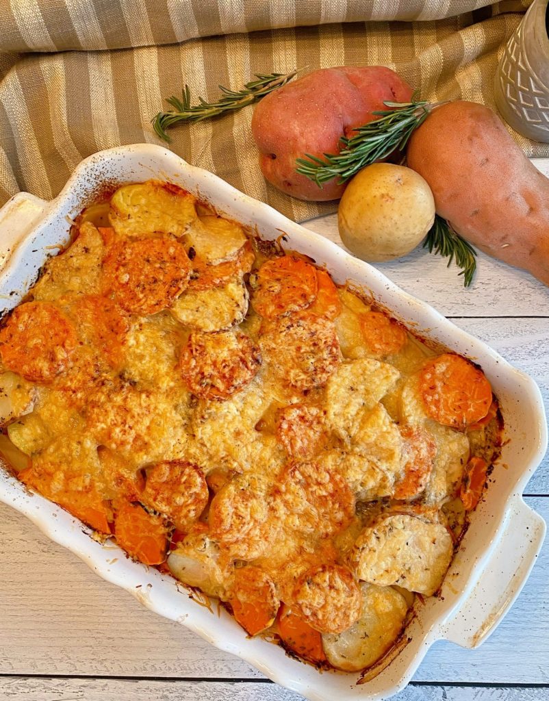 Rosemary Three-potato gratin in baking dish on cutting board.