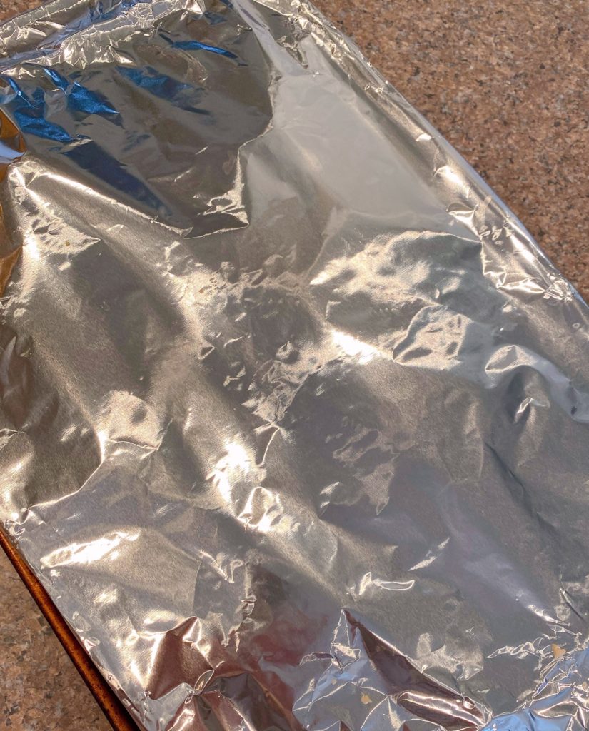 Baking dish covered with foil and ready to bake in the oven.