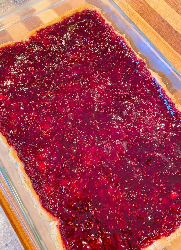 Jam baked onto crust in baking dish.