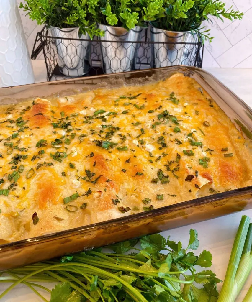 Pan full of baked chicken enchiladas.