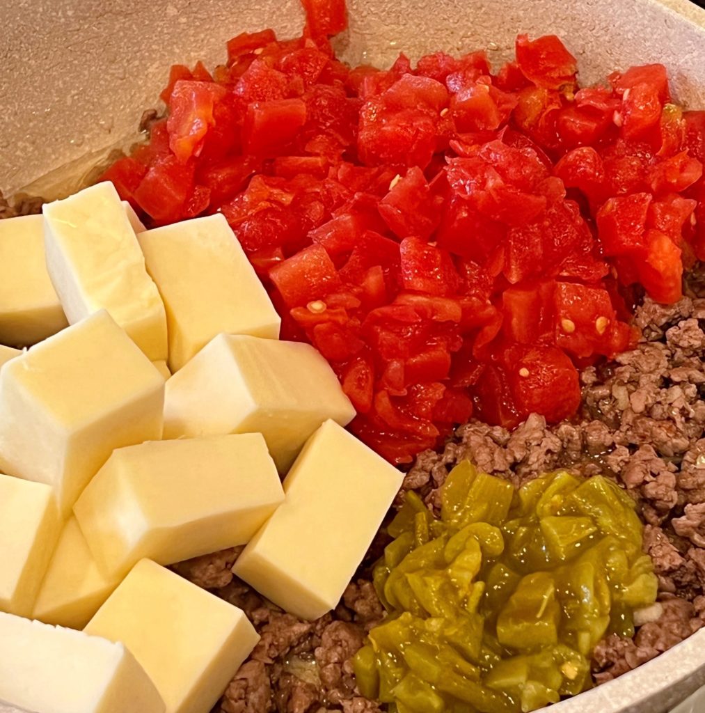 Adding diced green chilies and monterey jack cheese.