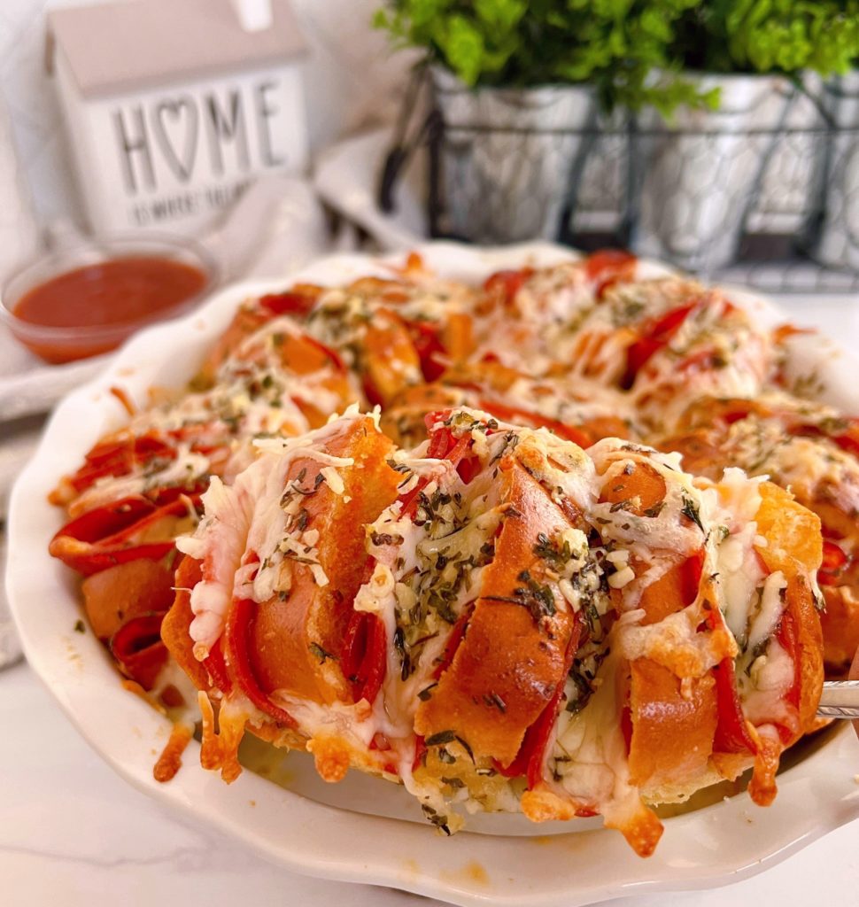 Pizza Sliders in a white baking dish .