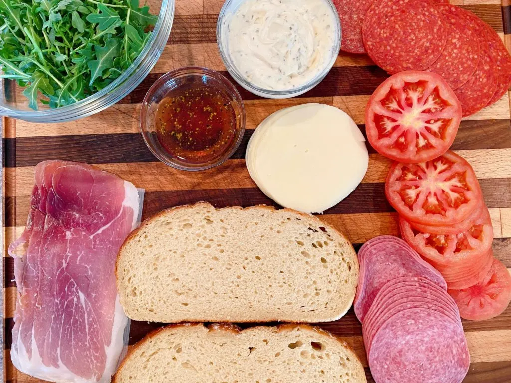 All sandwich ingredients on a cutting board.