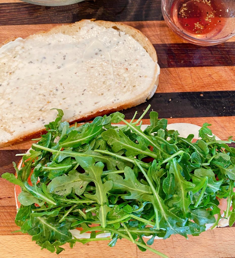 Arugula on top of sandwich.