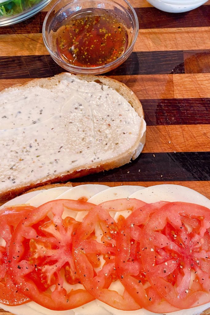 Cheese and tomatoes on top of lunch meat.