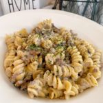 White shallow bowl full of a serving of Ground Beef Stroganoff.