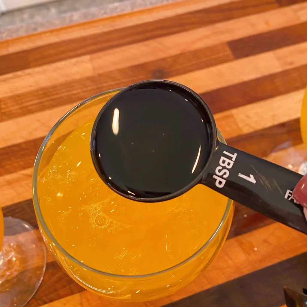 Adding Simple Syrup to Passion Fruit Juice.