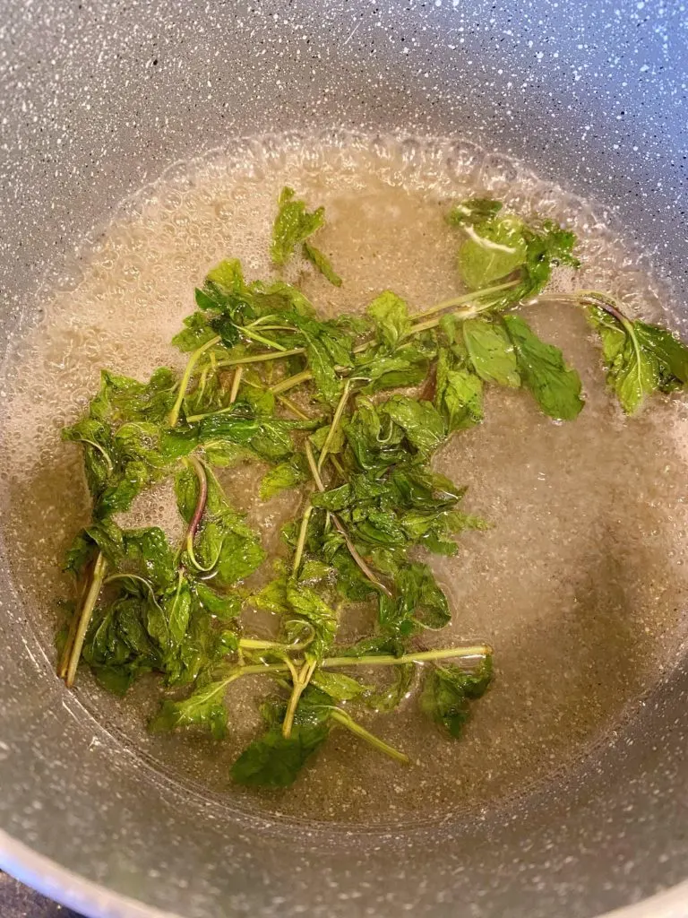 Mint, Water, and Sugar boiling in pan.