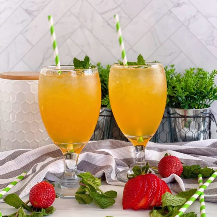 Two glasses filled with Nonalcoholic Passion Fruit Julep