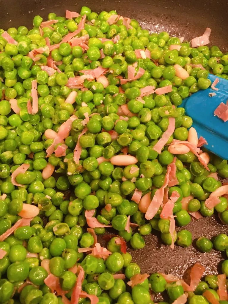 Adding Pine Nuts to Peas and Prosciutto.