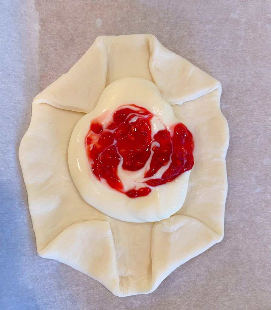 Raspberry Sauce swirled in cream cheese mixture.