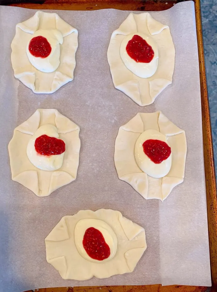 Raspberry Sauce on top of cream cheese centers.