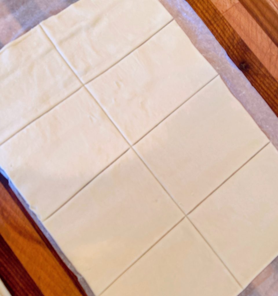 Puff Pastry rolled out on parchment paper.