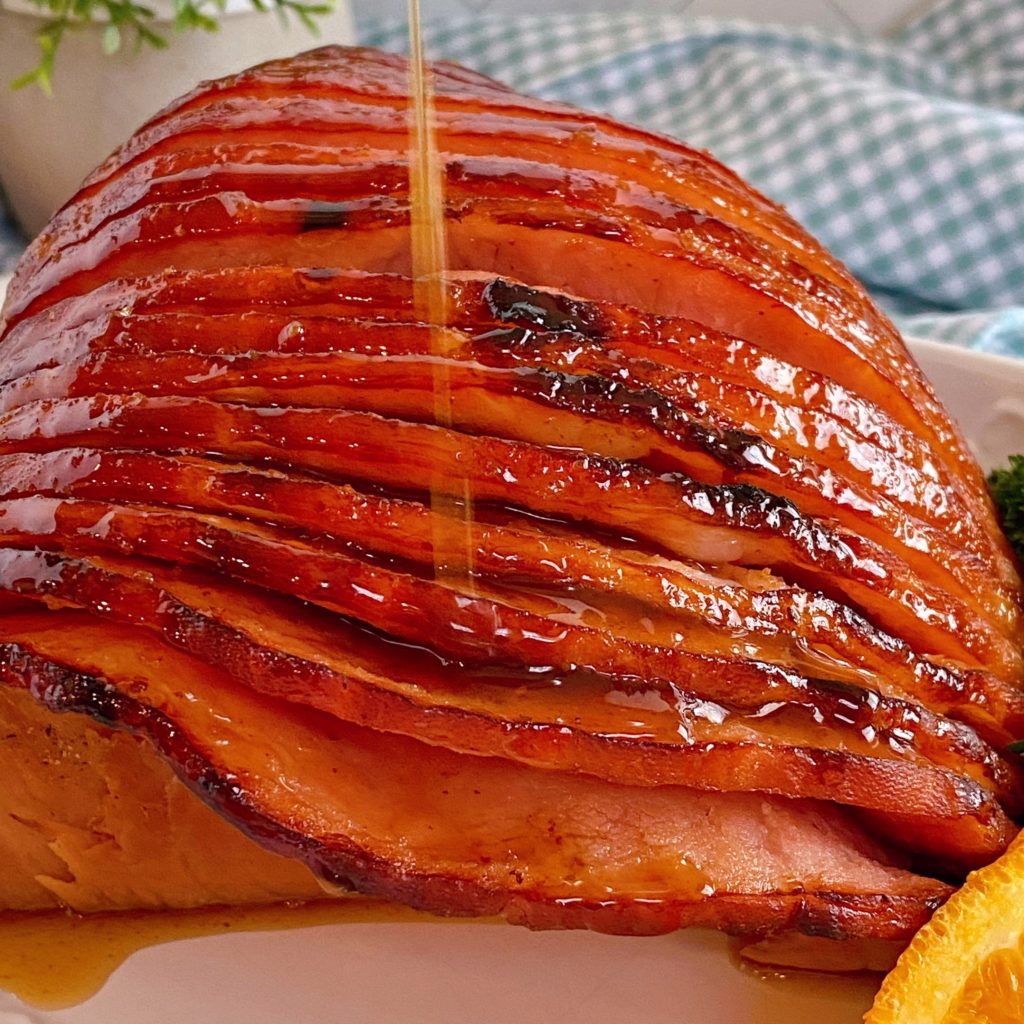 Pouring additional glaze on top of baked ham.