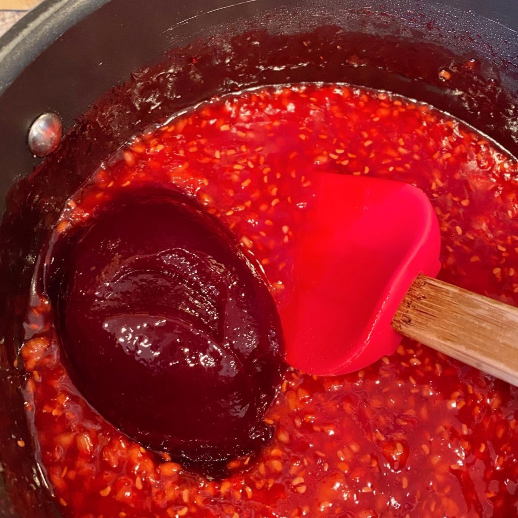 Adding seedless jam to filling mixture.