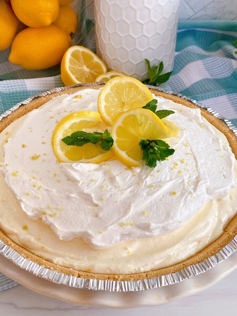 Lemon Cream Ice Box Pie with lemon slices for garnish and mint sprigs.
