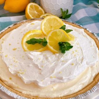 Lemon Cream Ice Box Pie with lemon slices for garnish and mint sprigs.