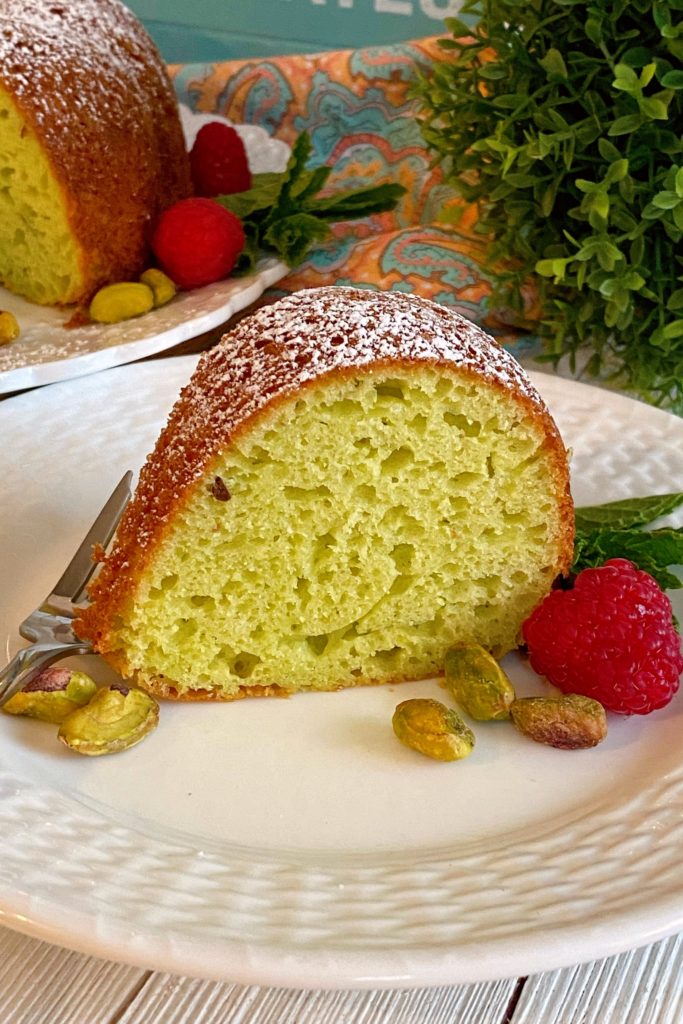 Pistachio Cake slice on a white serving plate.