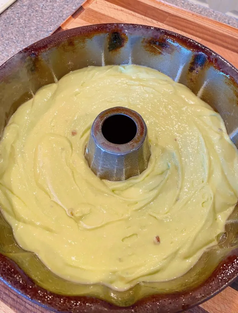 Cake batter spread evenly in bundt pan.