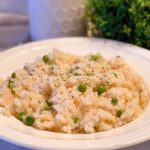 One Pot Oven Parmesan Risotto in a white bowl with peas.