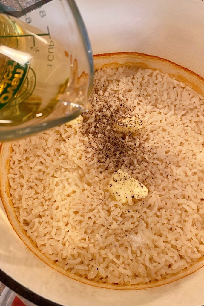 Adding the wine and other ingredients to the risotto.