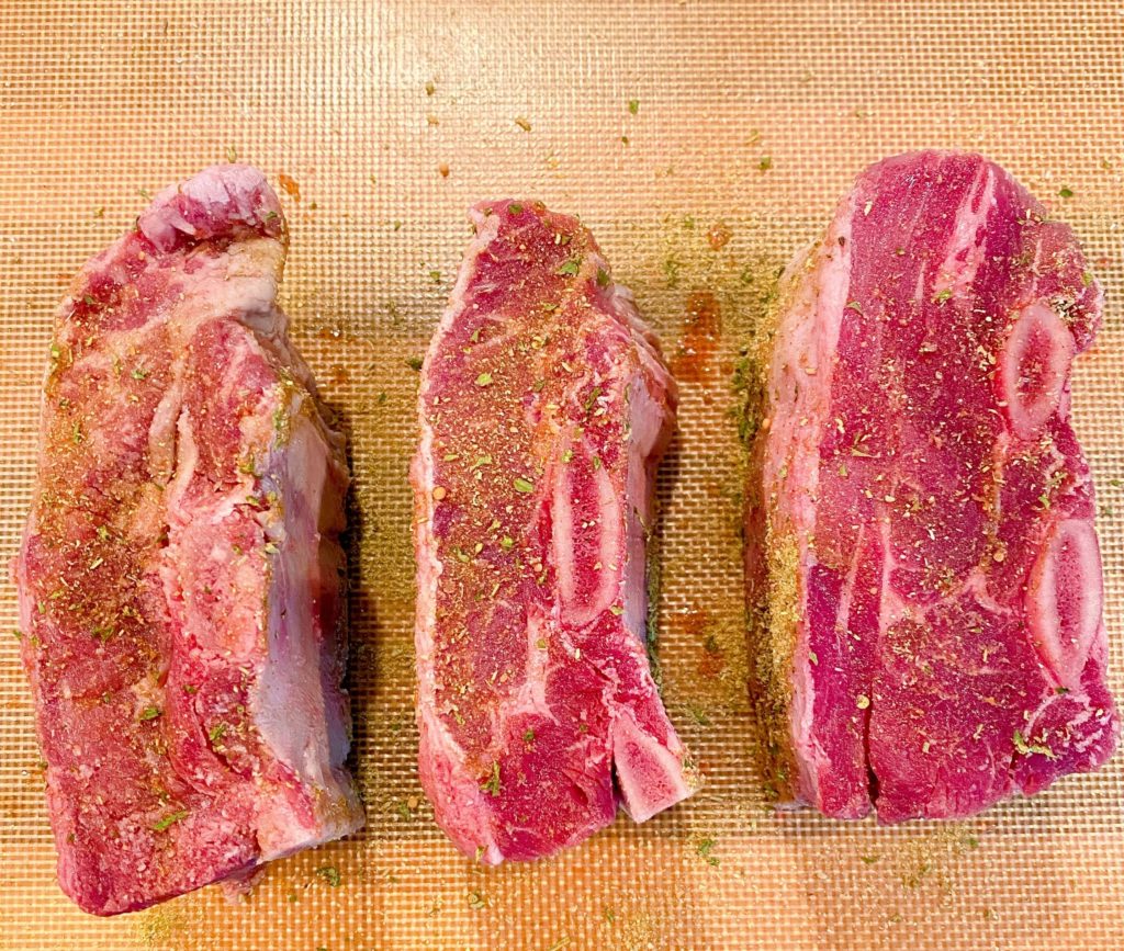 3 Beef Short Ribs on a mat seasoned with Dan-O's Seasoning.