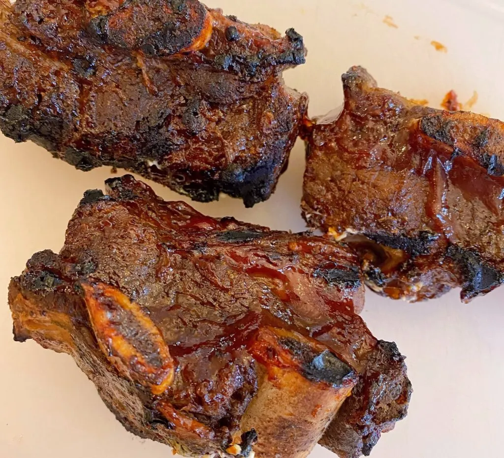 Ribs after grilling on a cutting board.