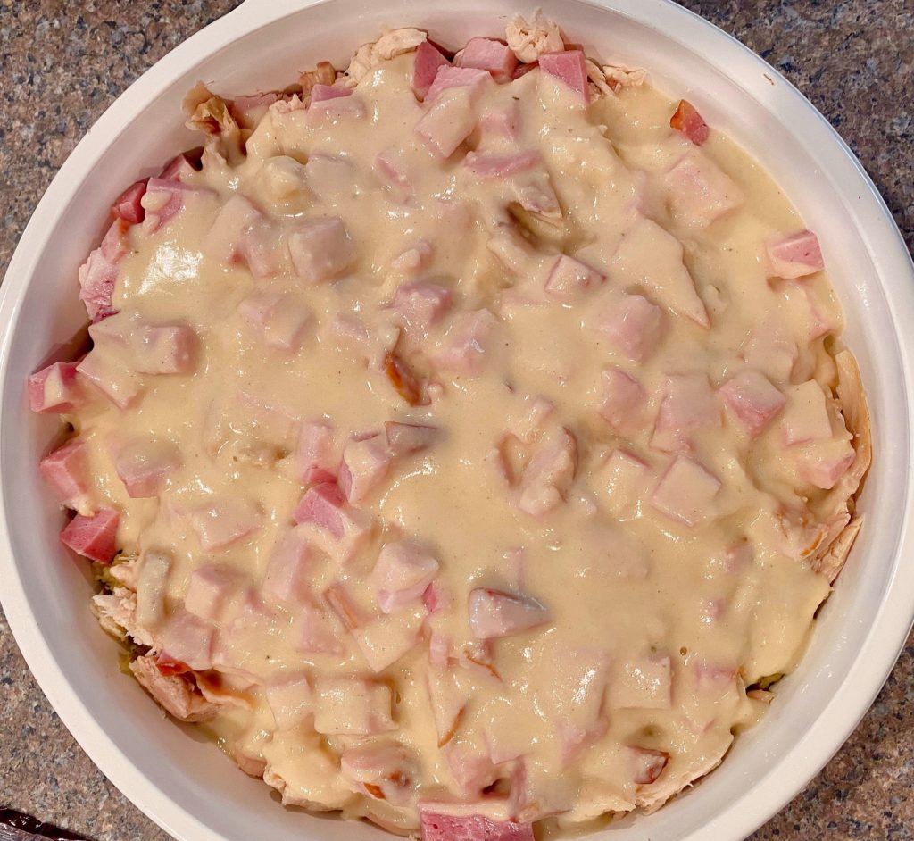 Creamy Mustard Sauce over the top of the stuffing, chicken, and ham.