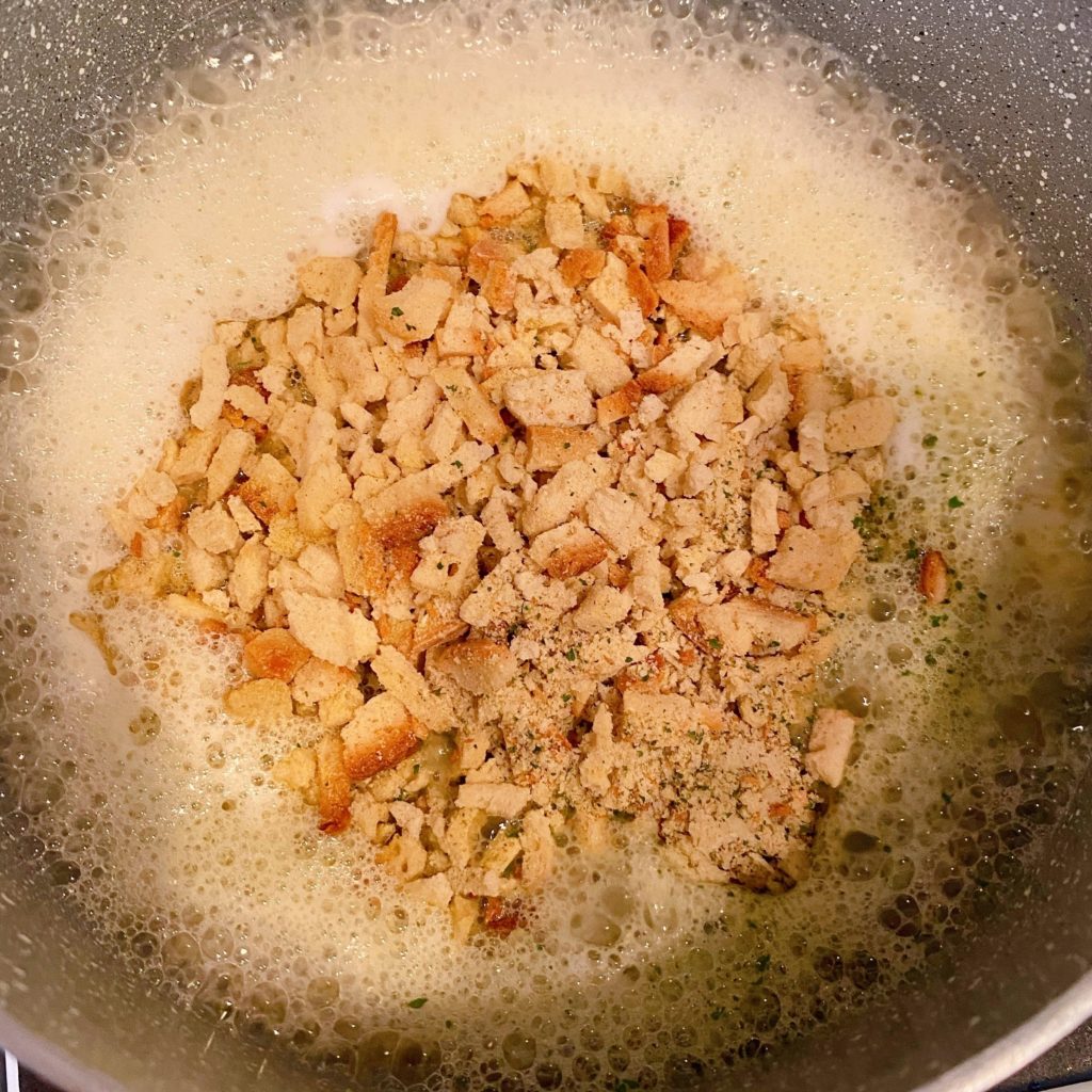 Stuffing mix ingredients in a sauce pan with boiling water and butter.