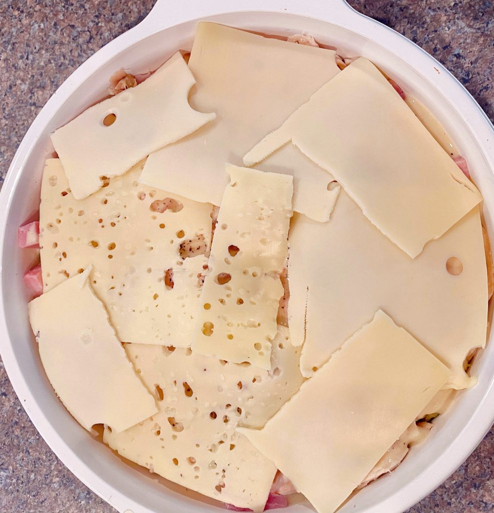 Slices of Swiss cheese on top of the casserole.