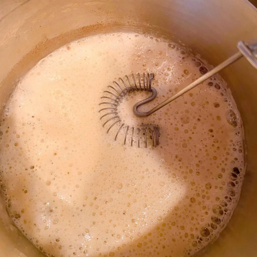 Flour and butter in sauce pan being whisked to combine.