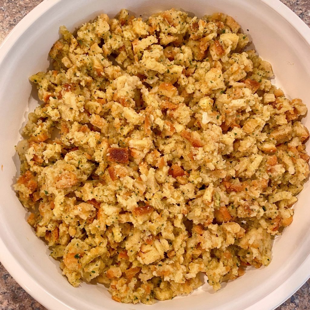 Stuffing spread in the bottom of a casserole dish.