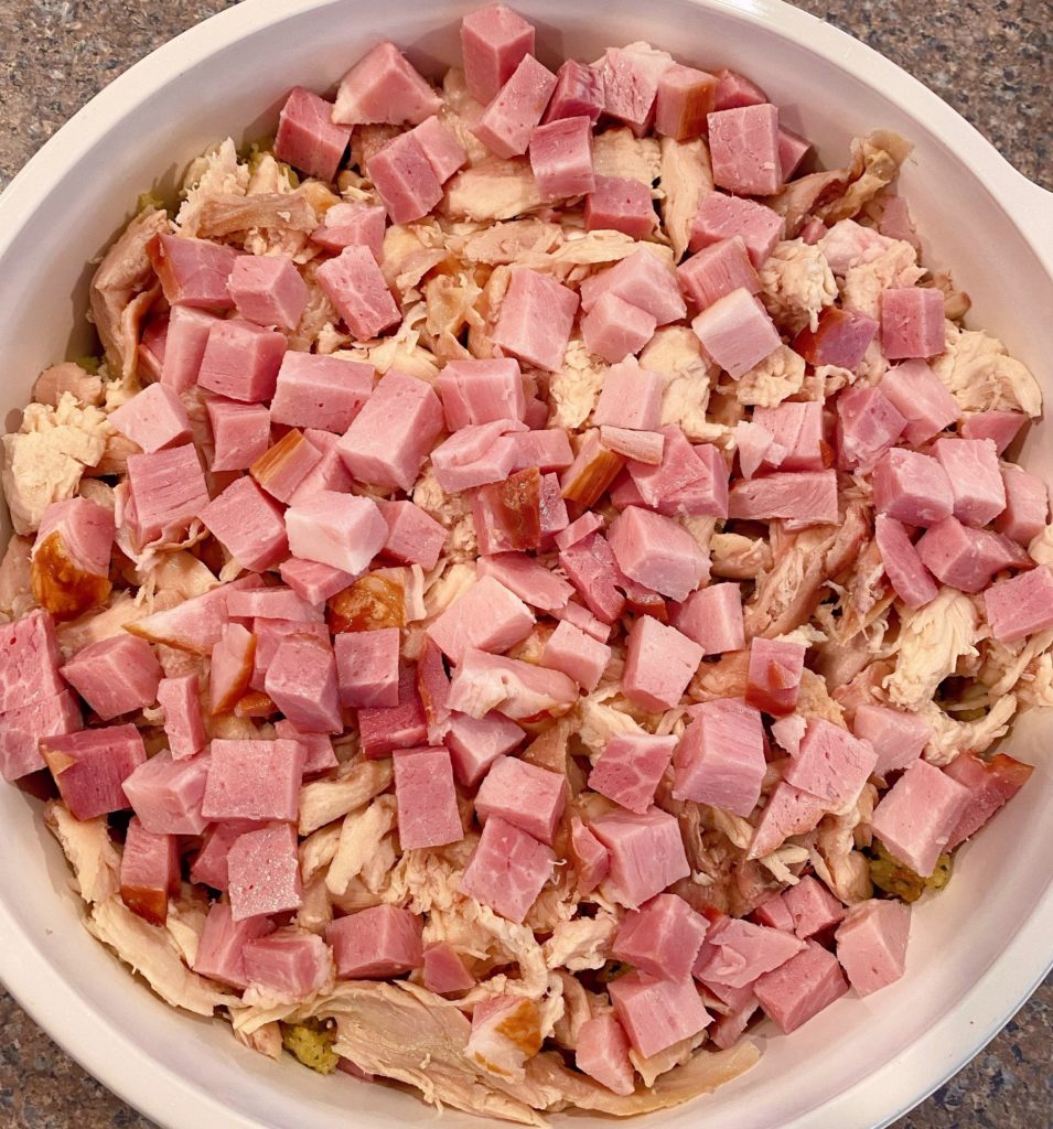 Top chicken with cubed ham.