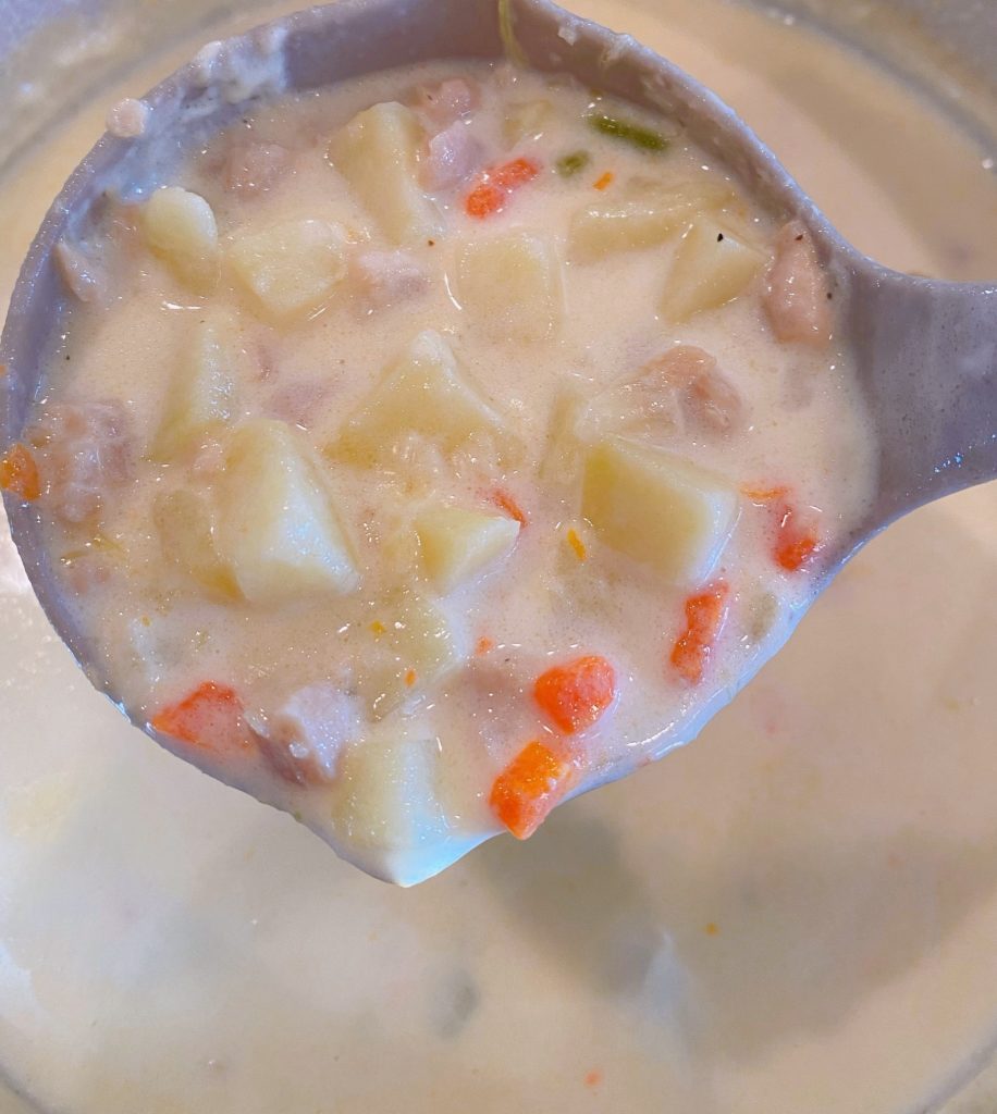 Clam Chowder in a ladle. 