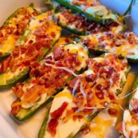Stuffed Grilled Jalapeno Poppers in a white serving dish.
