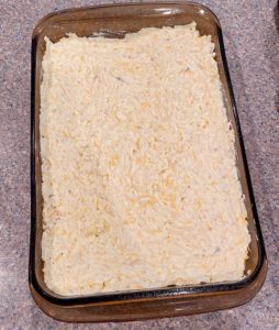 Baking dish filled with cheesy potatoes.
