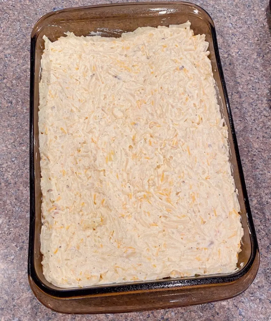 Baking dish filled with cheesy potatoes. 