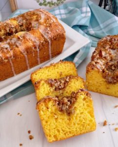Slices of Lemon Streusel Bread with whole loaves in the background.
