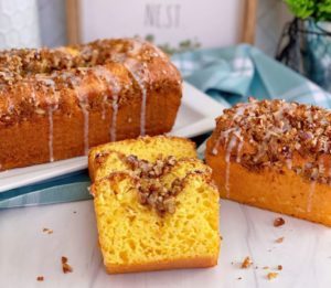 Lemon Streusel Quick Cake Mix Bread sliced and staggered on top of each other with larger loaves in the background.