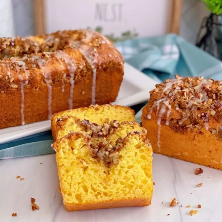 Lemon Streusel Quick Cake Mix Bread sliced and staggered on top of each other with larger loaves in the background.