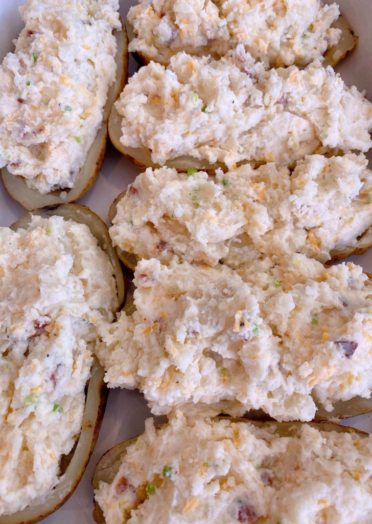 Twice Stuffed potatoes stuffed with filling in a casserole dish.