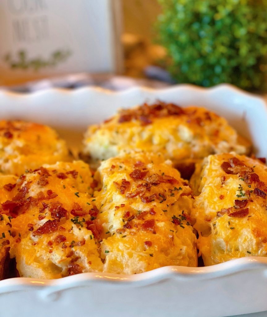 Best Every Loaded Twice Baked Potatoes nestled in a white casserole dish after coming out of the oven.